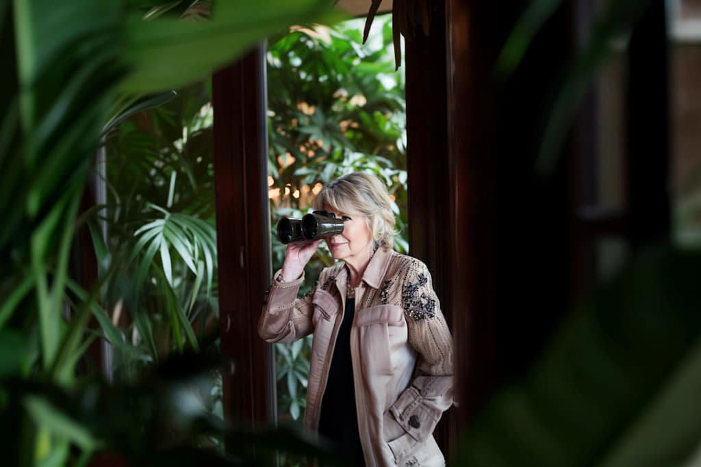 Martha Stewart looking at Ryan Reynolds through binoculars